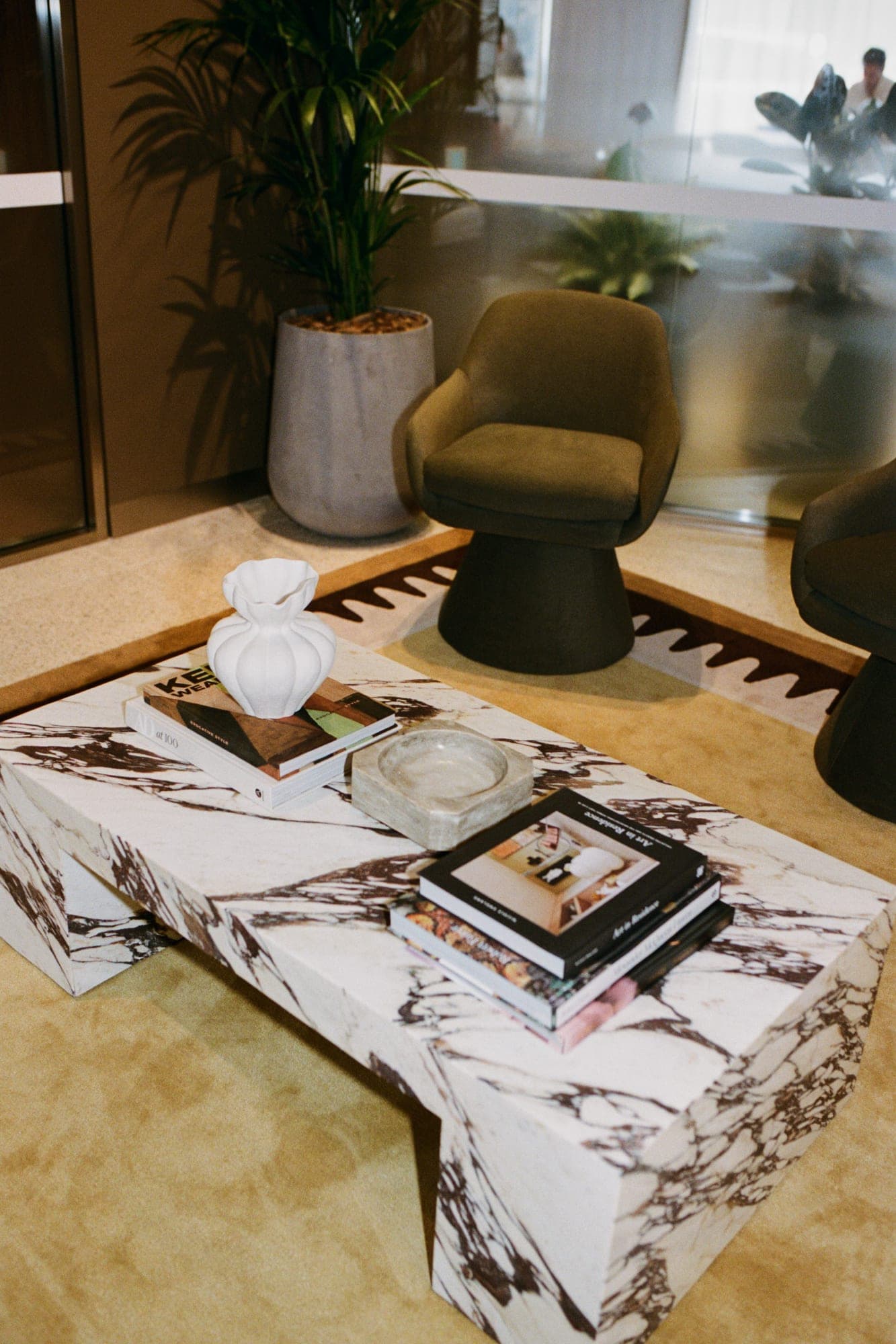 A marble table with design books at the studio